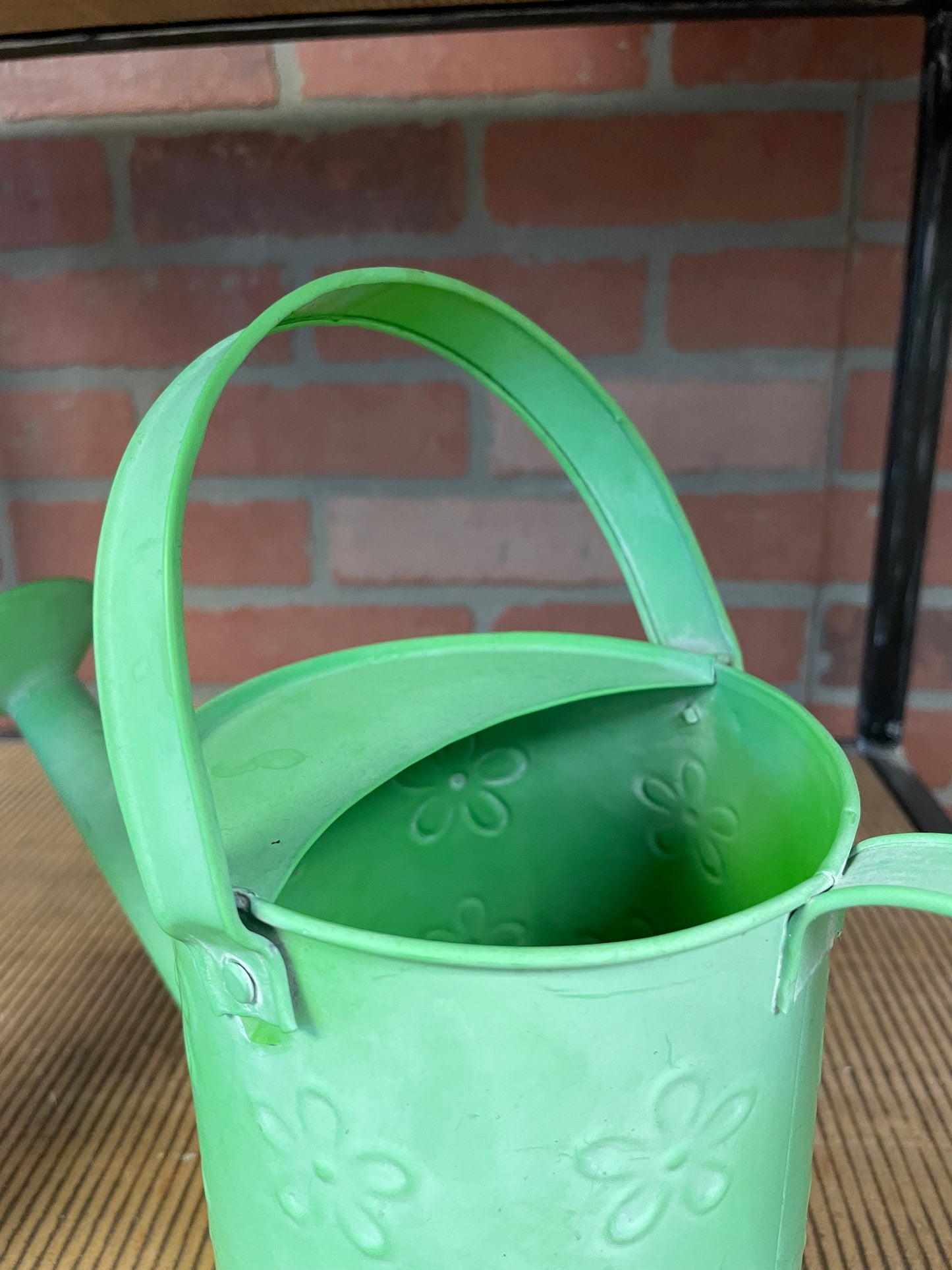 Green watering can with swing handle